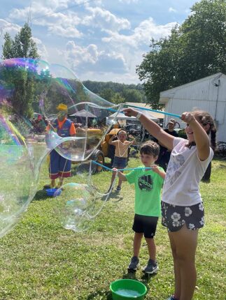 Children making giant bubbles outdoors