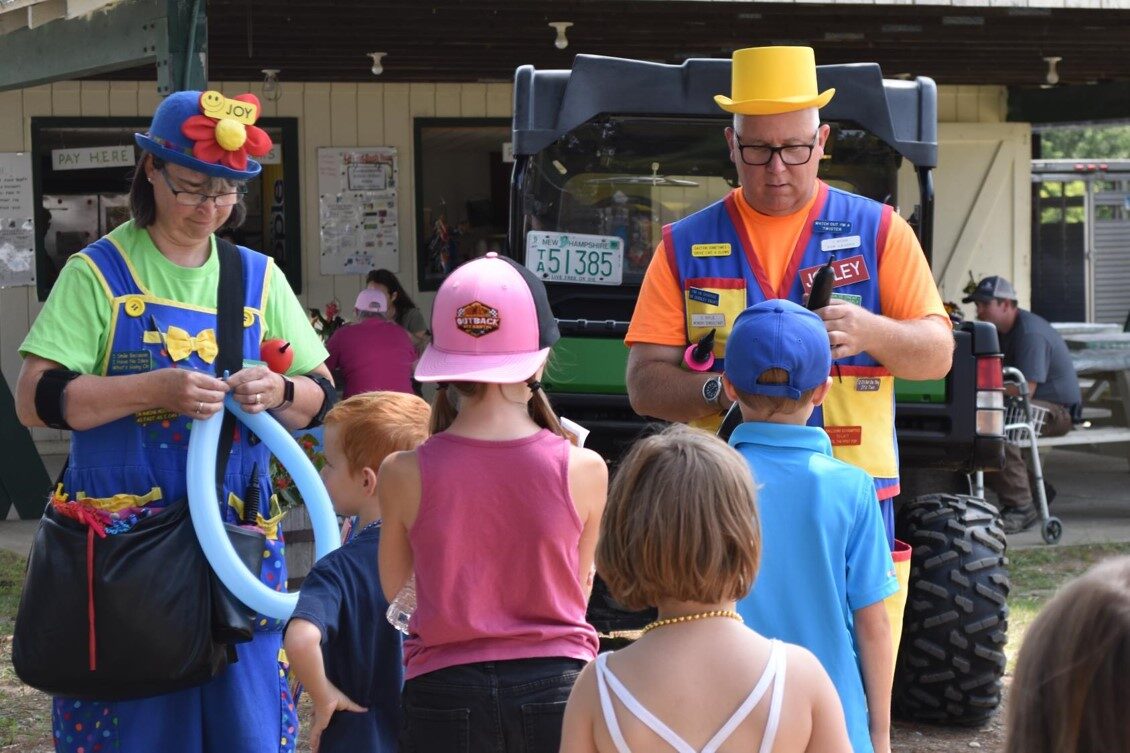 Lewy and his wife twisting balloon animals for kids